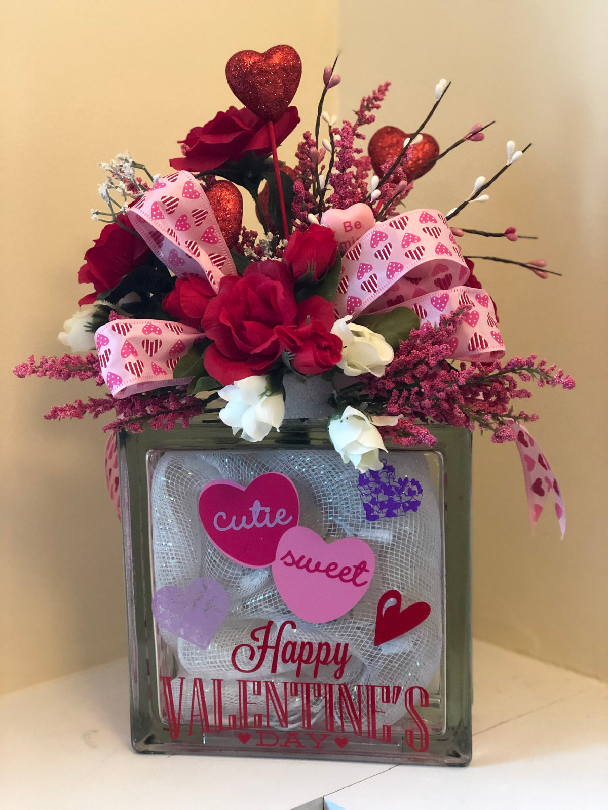 Front view of the Valentine's glass block with red roses and pink heart ribbon