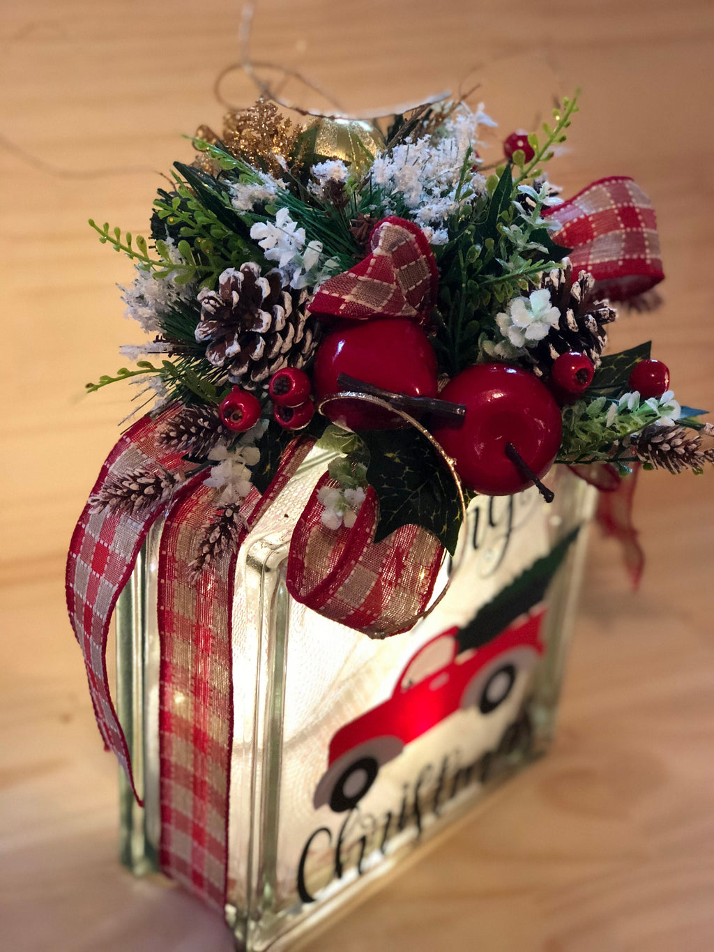 Side view of the lit red truck light box showing the plaid ribbon wrap