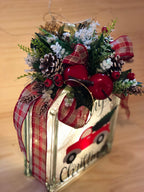 Side view of the lit red truck light box showing the plaid ribbon wrap