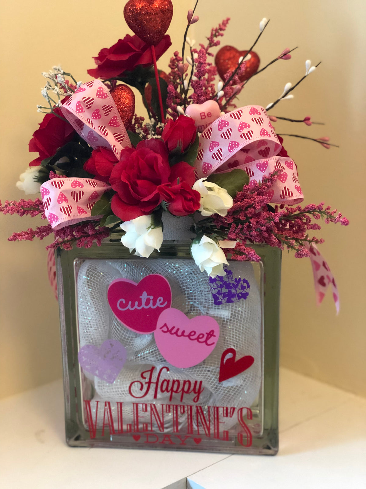 Happy Valentine's glass block with Cutie and Sweet candy hearts, topped with red roses and pink heart ribbon