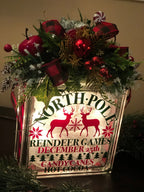 Reindeer Games light box with red ornaments and plaid ribbon on top