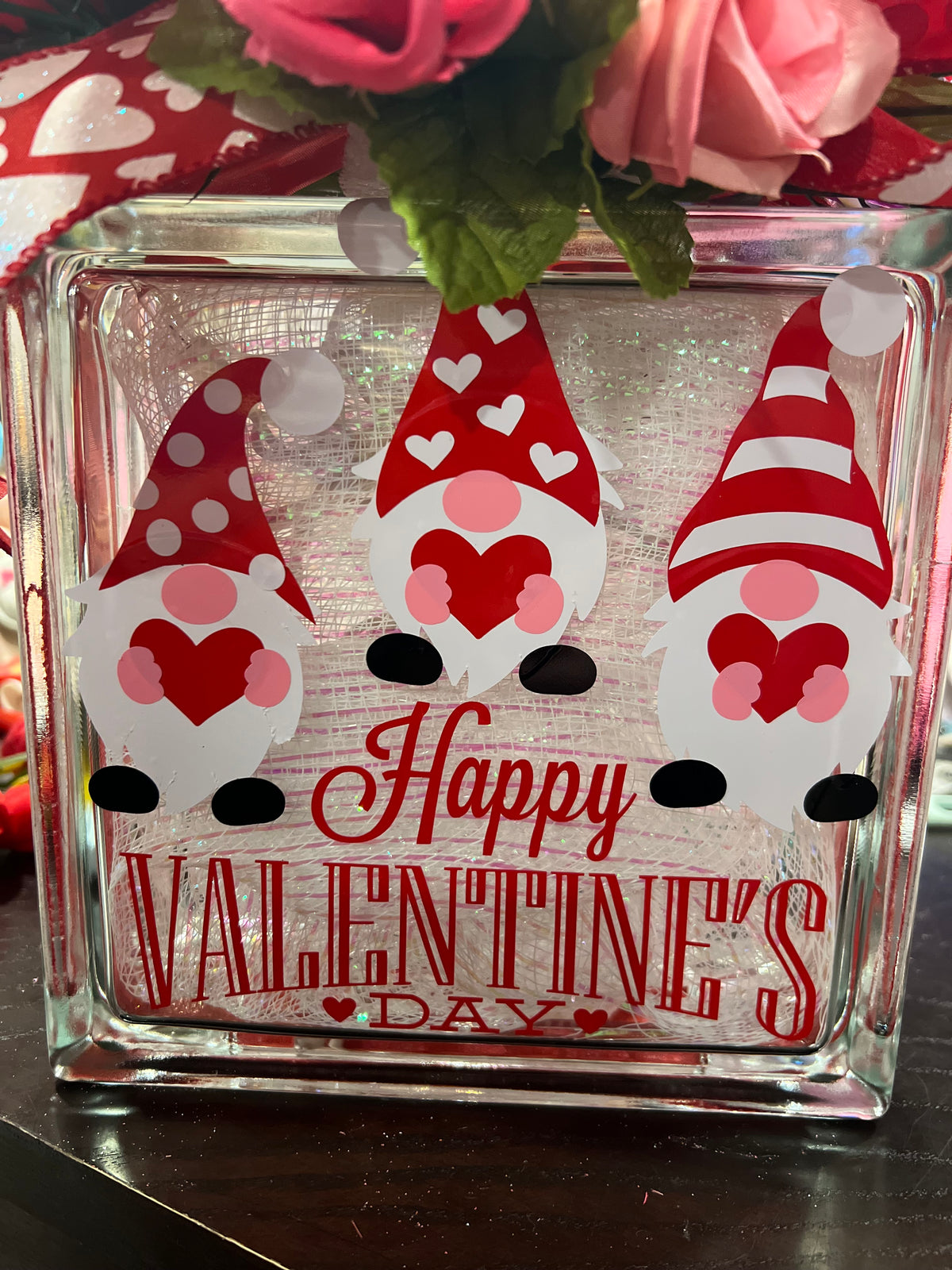Close-up of three Valentine gnomes and Happy Valentine's lettering on glass