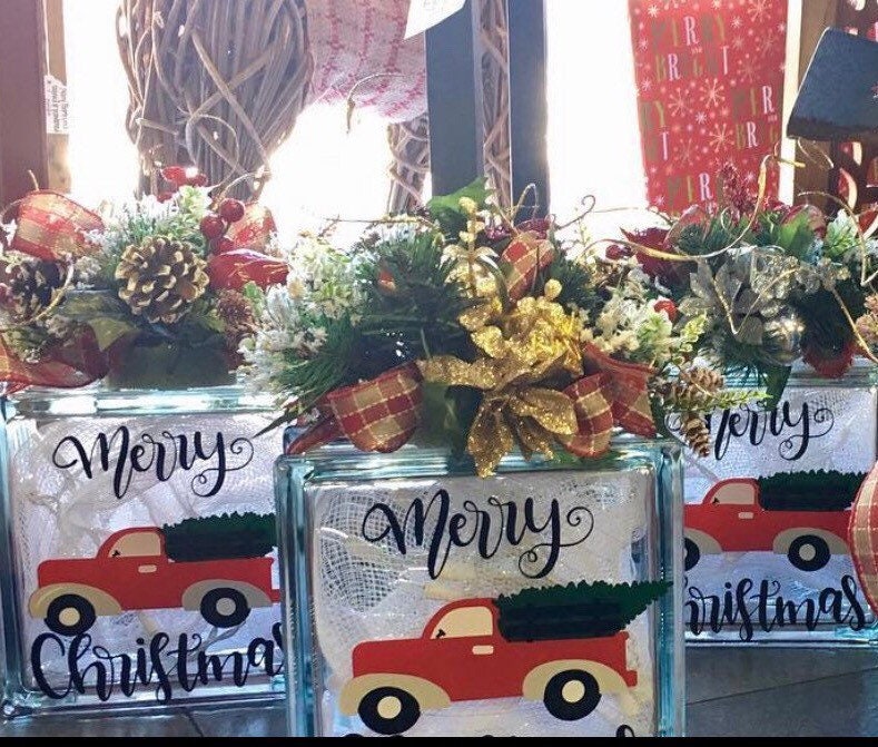 Three vintage truck Merry Christmas light boxes with different floral toppers