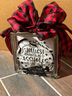 Angled view of the funny Christmas quote glass block on a table